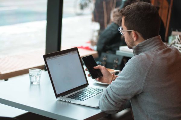 endpoint security man with laptop and phone